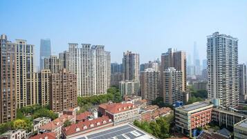 A high-rise residential area with multiple apartment buildings, a sports field, and a school building.