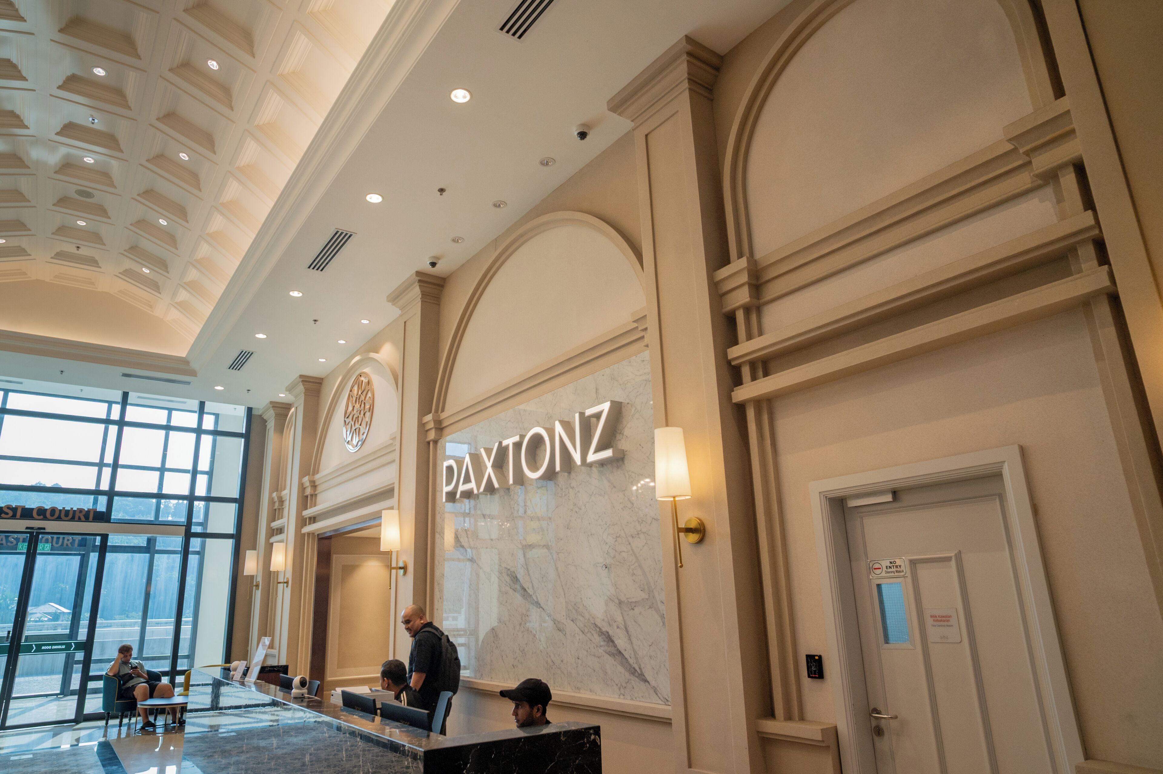 Eine Lobby mit einer Marmorwand, auf der der Name 'PAXTONZ' steht.