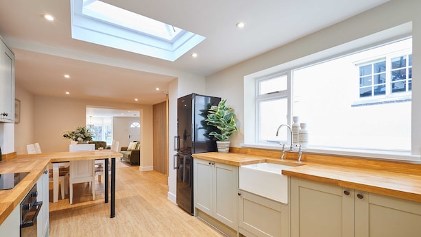 A modern kitchen with a skylight, wooden countertops, and a built-in sink. - Host Stay Ginger Bread Cottage (Middlesbrough)