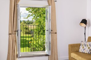 Enjoy a view of the garden or park from the balcony through the large window.