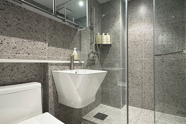 Shower, hair dryer, slippers, towels