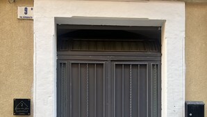 A double door with a metal handle, a small brass plate, and a keypad lock on the wall to the left. - Boaters' Home 2, Catania (Catania)