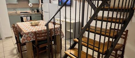 A staircase with wooden steps and metal railings leading to an upper floor.