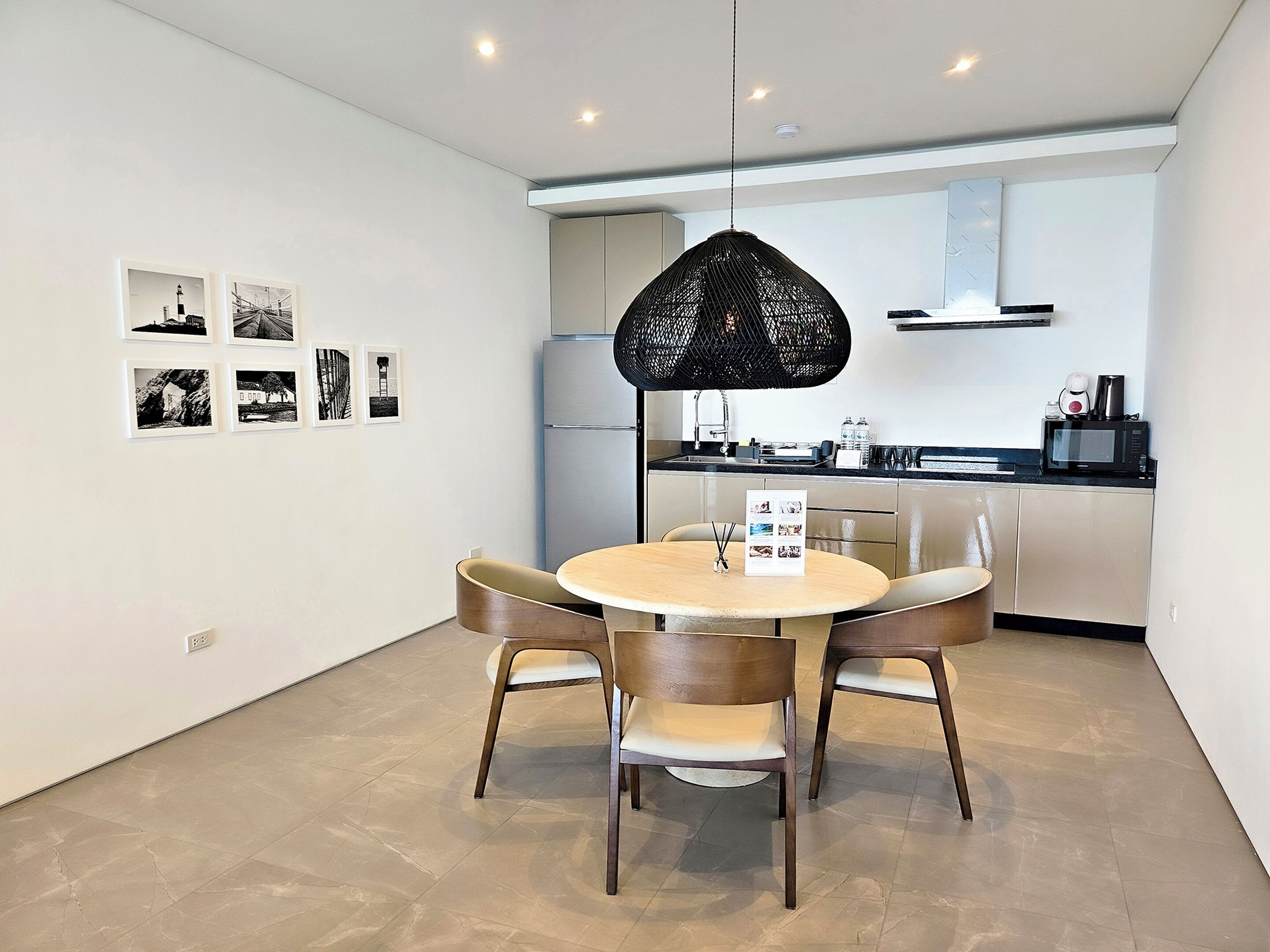 A modern kitchen with a built-in oven, a microwave, and a coffee maker on the counter.