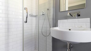 A modern bathroom with a glass shower enclosure, a white sink, and a mirror above the sink. - Italianway Easy - Rosmini 13 B (Milan)