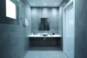 A modern bathroom with a large mirror, a round sink, and a toilet. - Loft Centrale by Deserve (Paphos)