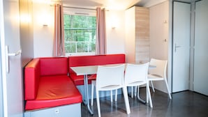 A compact room with a red bench, white table, and chairs. - Chalet in Olloy-sur-viroin With Patio (Viroinval)