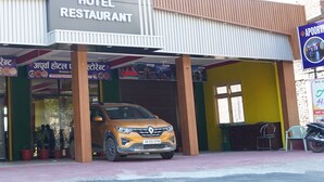A hotel with a sign reading "APORVA HOTEL RESTAURANT".