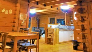A wooden cabin interior with a dining area, kitchen, and a loft bedroom. - Private Log Cabin-Perfect for families, large groups, Parties are welcome! (Nasu-gun Nasu-machi)