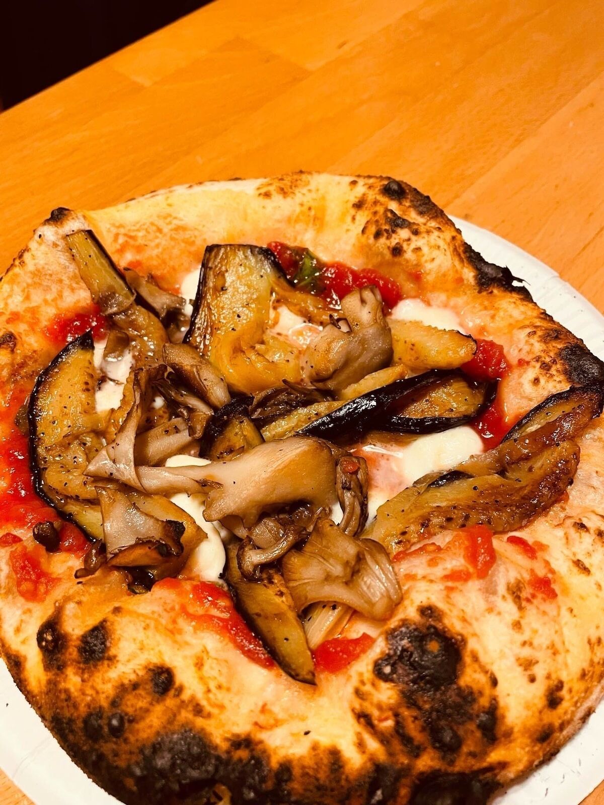 A pizza with toppings on a white plate.