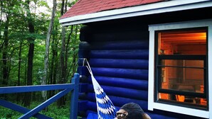 A log cabin with a red roof, a blue exterior, and a window with a warm interior light. - Private Log Cabin-Perfect for families, large groups, Parties are welcome! (Nasu-gun Nasu-machi)