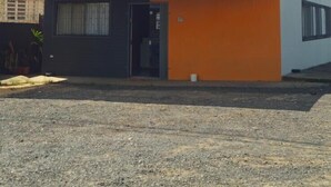A two-story building with a sign reading "AROMA HOTEL." - Aroma hotel (Imbaú)