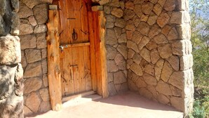 A stone-walled building with a wooden door.