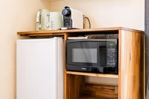 A compact kitchenette with a microwave, toaster, and a white refrigerator. - Stargazing Suite | Walk to Church + Lake | Sauna (Lake Tekapo)