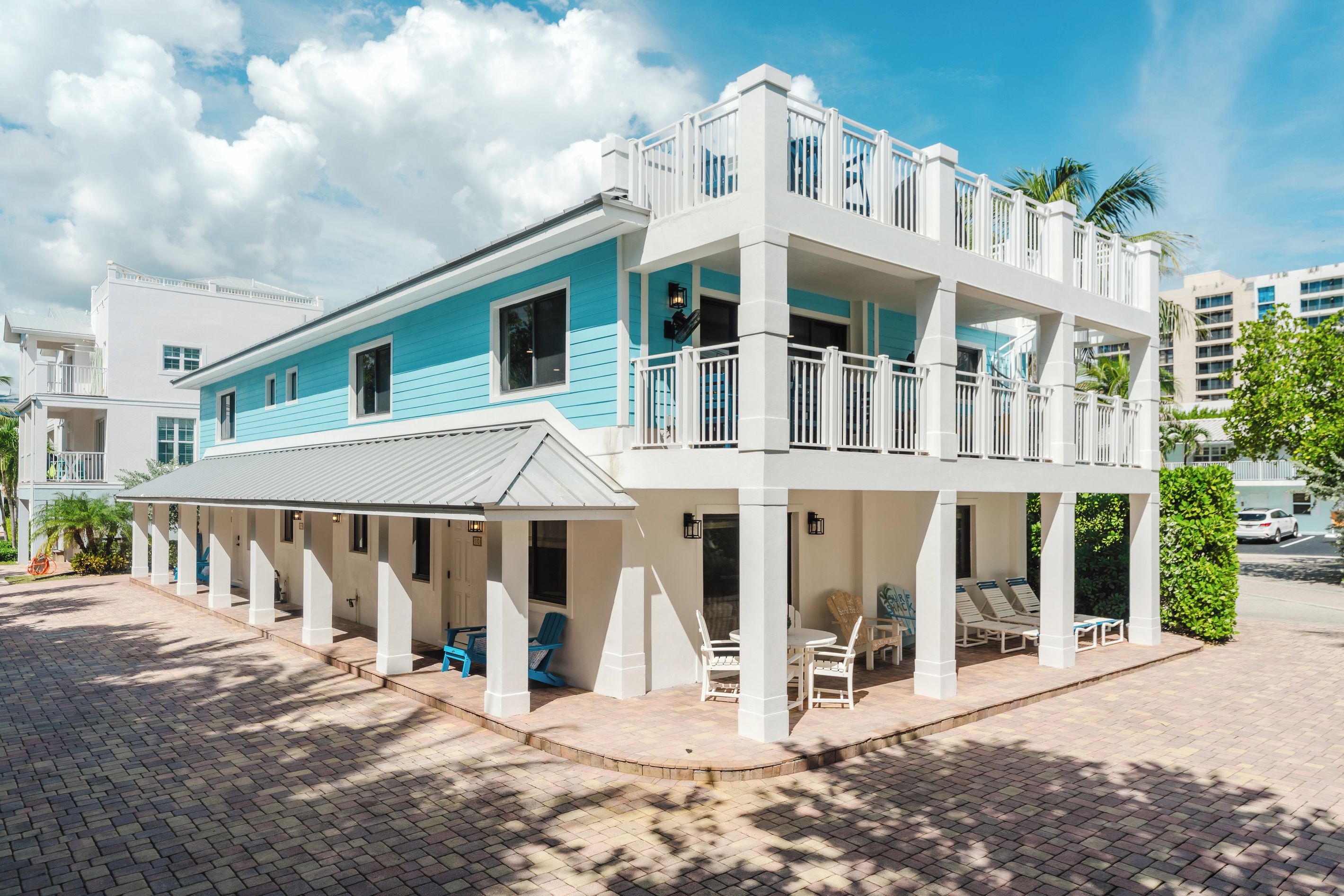 A two-story building with a balcony and outdoor seating area.