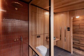 A modern bathroom with wooden paneling, a shower, and a toilet. - 'Engineers Hut 1823' in Historic Richmond (Richmond)