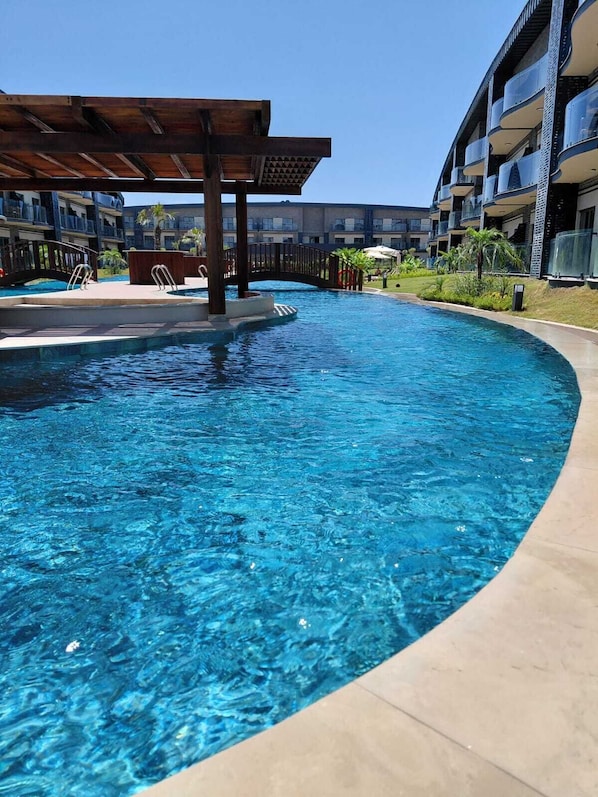 Seasonal outdoor pool, open 8:00 AM to 8:00 PM, pool umbrellas