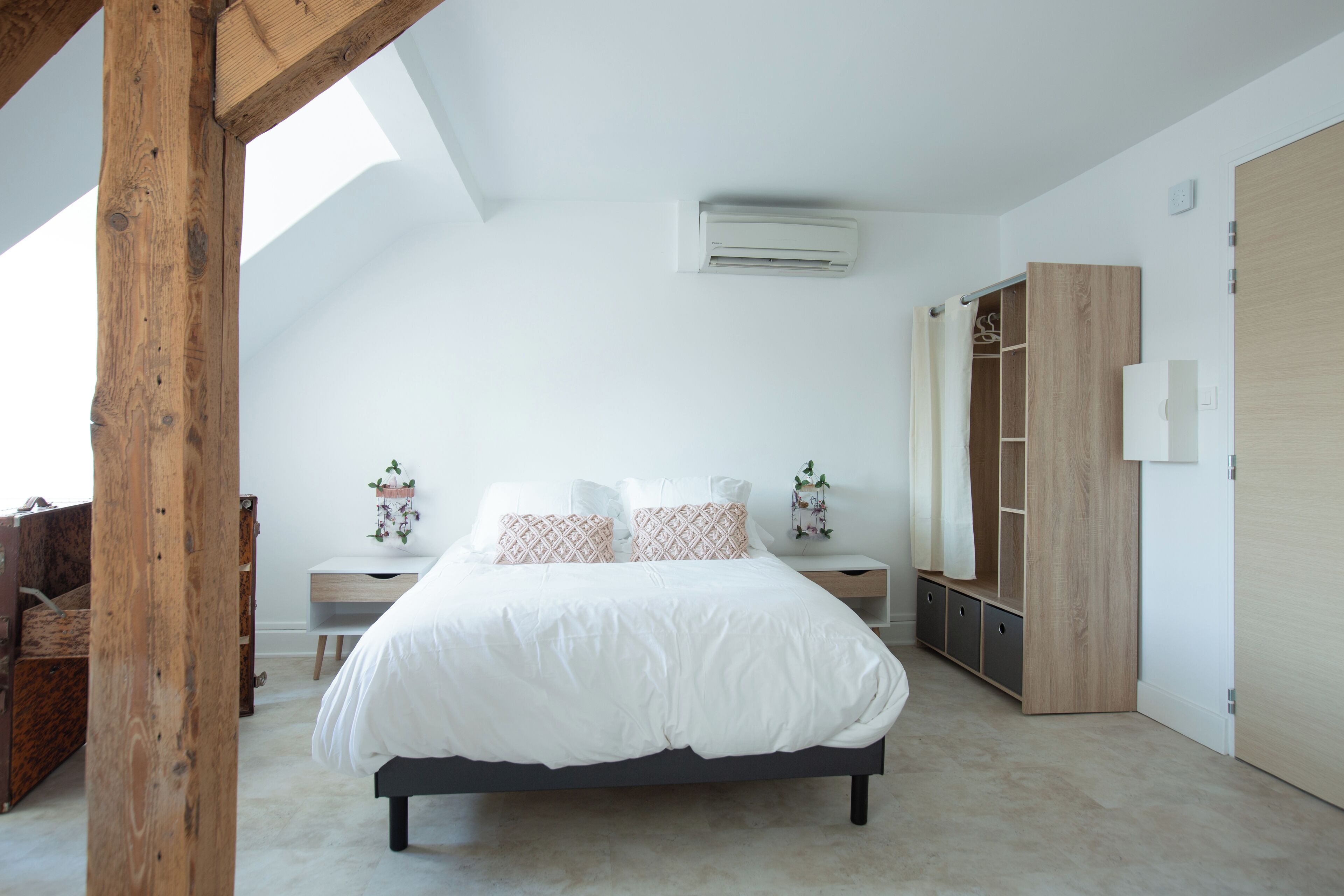 Une chambre à coucher avec un lit, une table de chevet et une armoire.