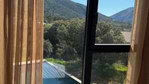 A view from a room with a large window overlooking a swimming pool and a mountainous landscape. - VILLA with private pool, near MONT VENTOUX and VAISON LA ROMAINE (Mollans-sur-Ouvèze)