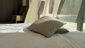A bedroom with a large bed, a chair, and sheer curtains allowing natural light. - VILLA with private pool, near MONT VENTOUX and VAISON LA ROMAINE (Mollans-sur-Ouvèze)