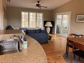 A modern kitchen with granite countertops, a built-in sink, and a ceiling fan. - Ohana Sunrise - VERY NICE 3BR, Close to the beach - Linens & Towels provided (Chincoteague)