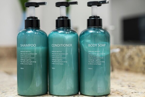 Three bottles of liquid soap on a countertop. - The Jupiter Hideaway (Jupiter)