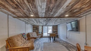 A spacious room with a wooden ceiling, a sofa, a table, and a foosball table. - Stunning, Spacious Mountain Home near Deadwood & 4X4 Trails (Lead)
