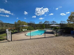 Seasonal outdoor pool, open 10:00 AM to 7:00 PM, pool umbrellas