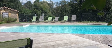 Seasonal outdoor pool, open 10:00 AM to 7:00 PM, pool umbrellas