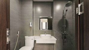 A modern bathroom with a toilet, sink, and shower. - Royal Lotus Apartment and Hotel Ha Noi (Hanoi)