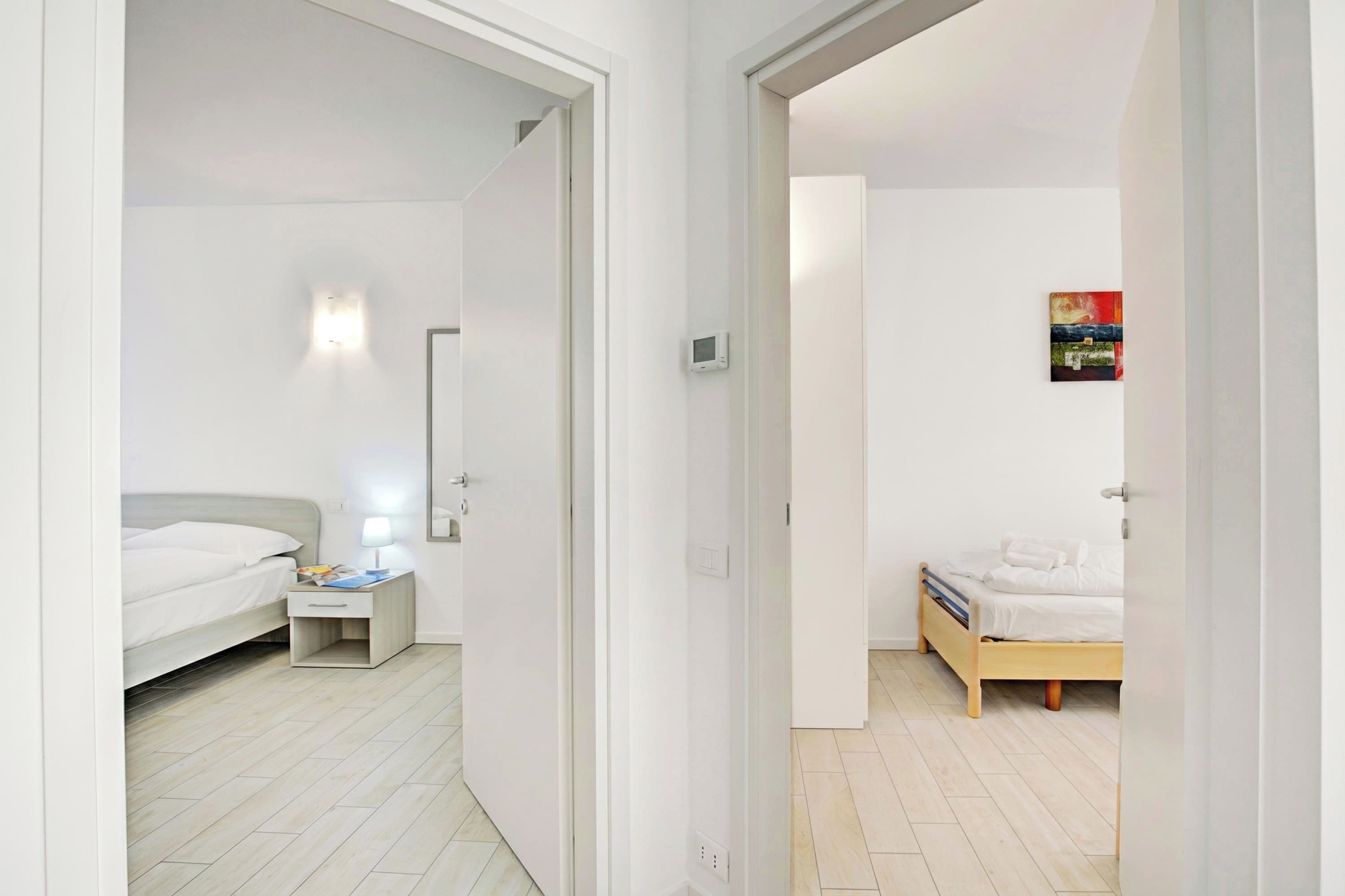 A modern bedroom with a bed, bedside table, and a nightstand.