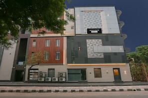 A multi-story building with a sign indicating 'Townhouse & Company Apartments.'