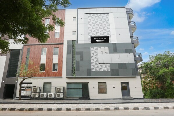 A multi-story building with a sign reading 'TOWNHOUSE.' - Classic Rohini Sector 18 Known as Relic (New Delhi)