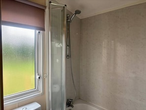 A glass-enclosed shower with a handheld showerhead, a window, and a bathtub. - Caravan in Holcot - Sleeps 6 - Maximum 6 People - Maximum 4 Adults per Booking -pet Friendly (Northampton)