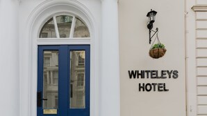 A building with a blue door and a sign that reads 'WHITELEYS HOTEL.' - Whiteleys Hotel (London)