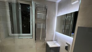 A modern bathroom with a glass shower enclosure, a sink, and a toilet. - Shawforth - 2 Beds - Sleeps 4 - Street Parking (Rochdale)
