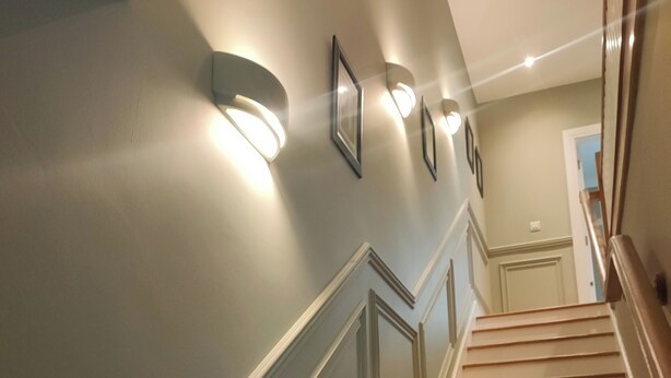 A staircase with wooden steps and white trim, leading to a landing with a door. - Cozy City Escape in Galway (Galway)