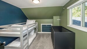 A room with bunk beds, a desk, and a window. - Love n Life Haven (Cincinnati)