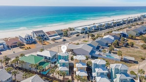 A coastal residential area with houses, a beach, and a road. - Turquoise Tail (Panama City Beach)