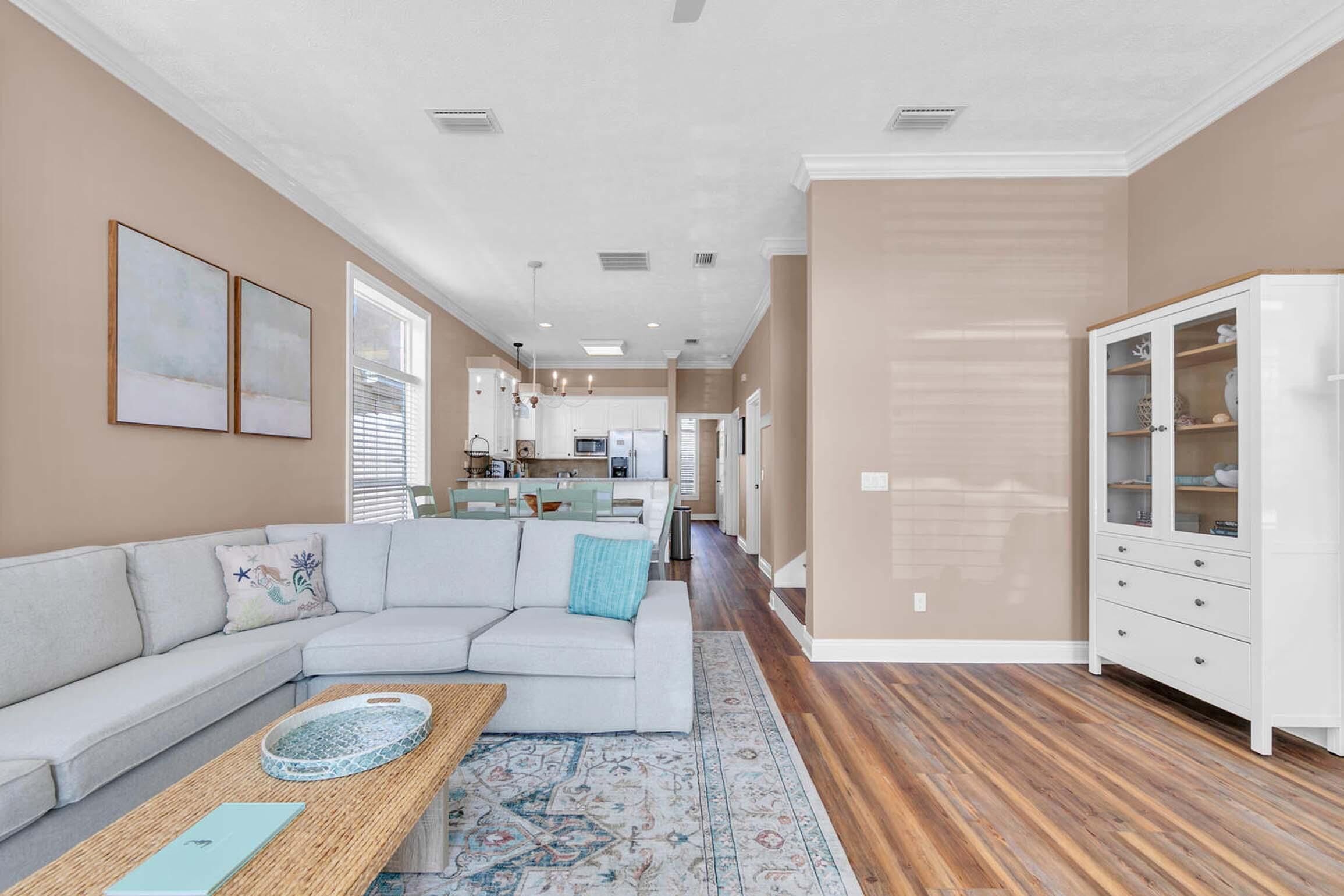 A modern living room with a sectional sofa, a coffee table, and a cabinet.