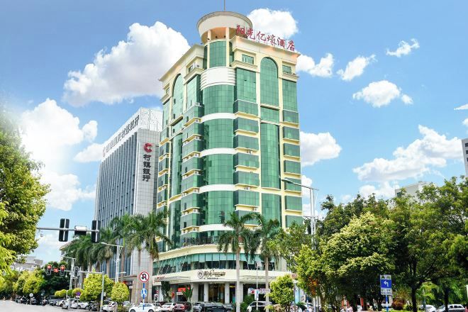 A multi-story hotel with a modern design, featuring a prominent entrance and signage.