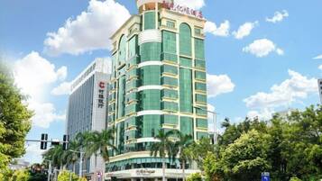 A multi-story hotel with a modern design, featuring a prominent entrance and signage.