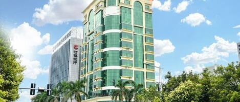 A multi-story hotel with a modern design, featuring a prominent entrance and signage.