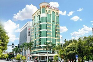 A multi-story hotel with a modern design, featuring a prominent entrance and signage.