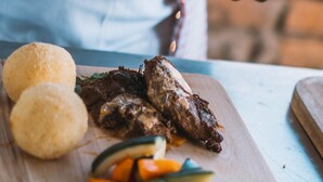 A chef preparing food with a wooden cutting board, a bowl, and a spoon. - Rafiki Retreat (Arusha)