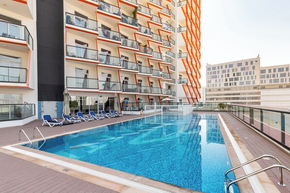 Piscina externa, guarda-sóis, espreguiçadeiras