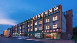 A hotel with multiple floors, featuring a prominent signboard with Chinese characters.