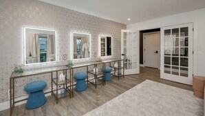 A modern bathroom with three vanity mirrors, a glass shower enclosure, and a wooden floor. -  5-Bedroom Retreat with Cowboy Pool, Sauna and More – 10 Min to Downtown Austin (Austin)