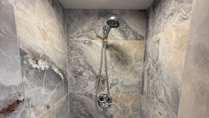 A small, tiled shower area with a handheld showerhead and a square light fixture on the ceiling. - private, Kitchenette, AC (Santa Barbara)