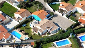 An aerial view of a residential area with multiple houses, each featuring a swimming pool and a tiled roof. - 🔥Is Oura Calling You?🔥4BD Sleeps 12 Jacuzzi Pool PingPong 5min Strip 10' beach (Albufeira)